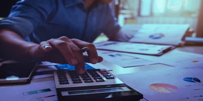 Business accounting concept, Business man using calculator with computer laptop, budget and loan paper in office.